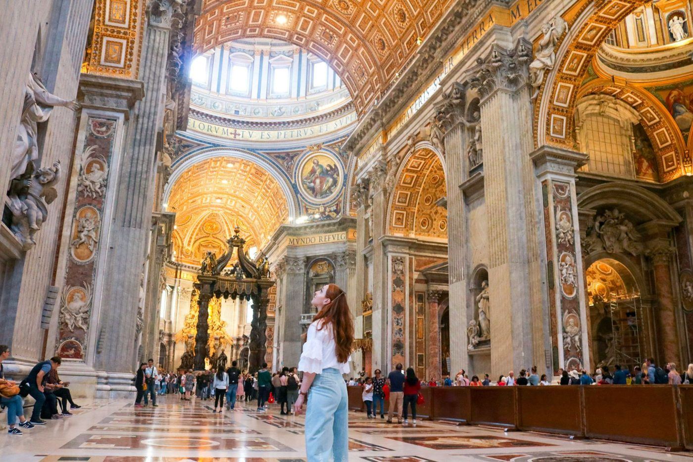 Inside St. Peter's Basilica, with light falling across the marble floor