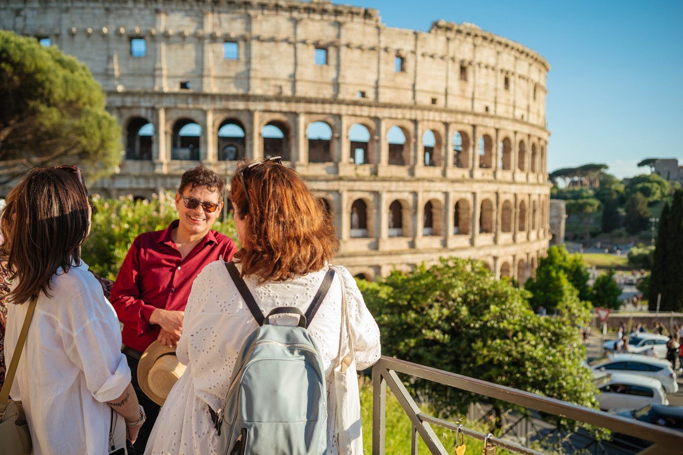 A small group with a guide in front of the Colosseum