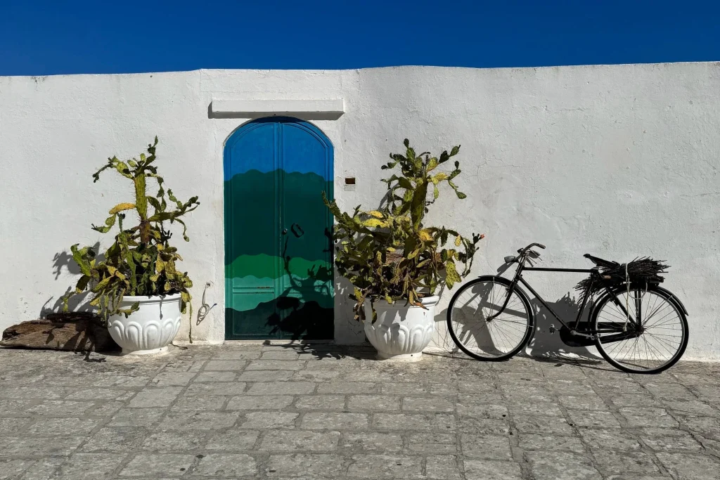 A whitewashed Puglia hill town under the morning sun