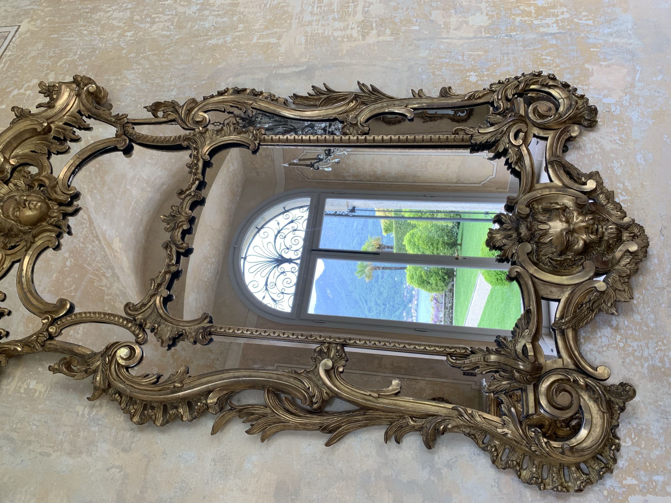 Baroque gilded mirror in Villa Balbiano reflecting Lake Como