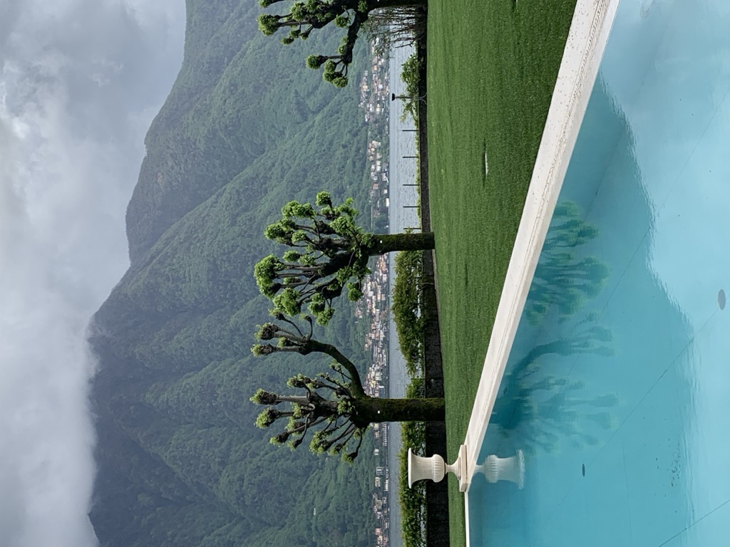 Villa Balbiano infinity pool overlooking Lake Como with pollarded plane trees
