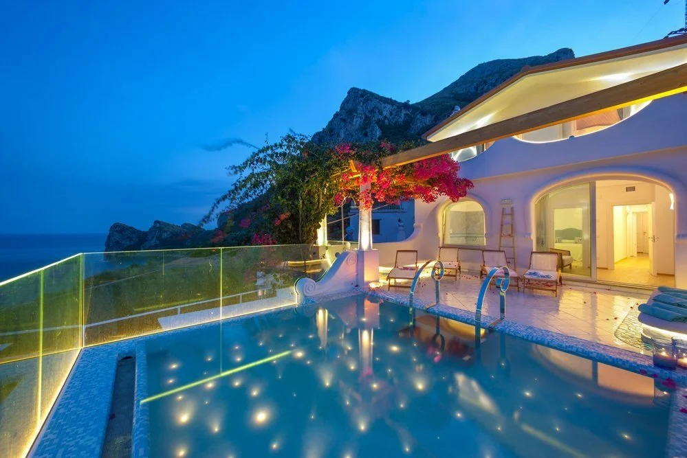 villa serena pool at night overlooking amalfi coast