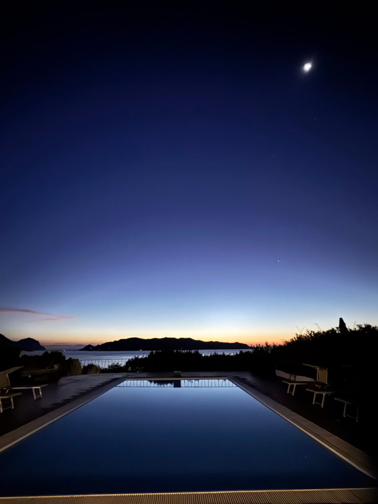 Villa pool at dusk facing Tavolara Island and the sea, Sardinia