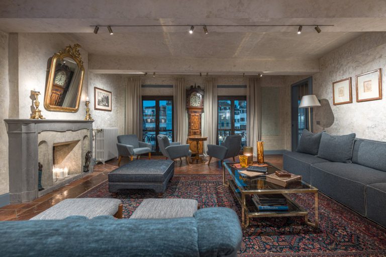 Villa Valorea, Florence — Living room with stone fireplace
