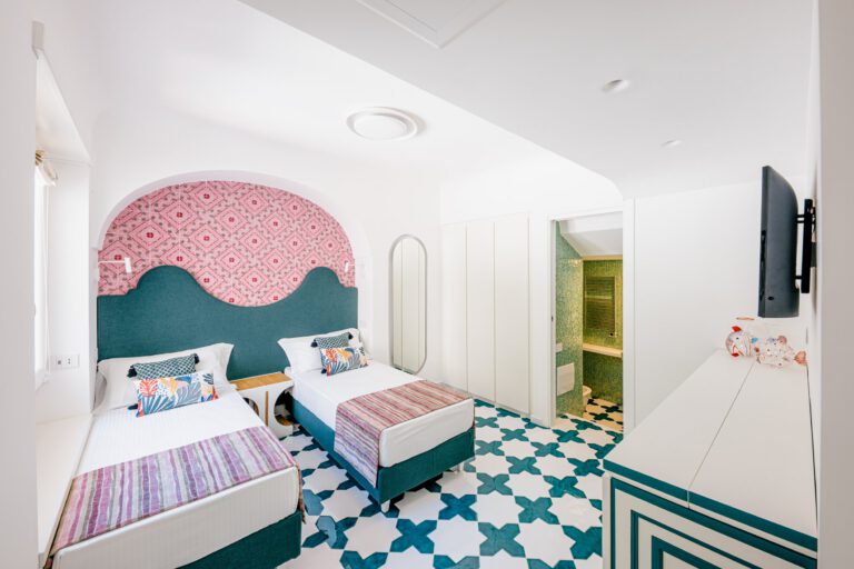 Villa Marelda — Bedroom with arched windows and blue tile floor