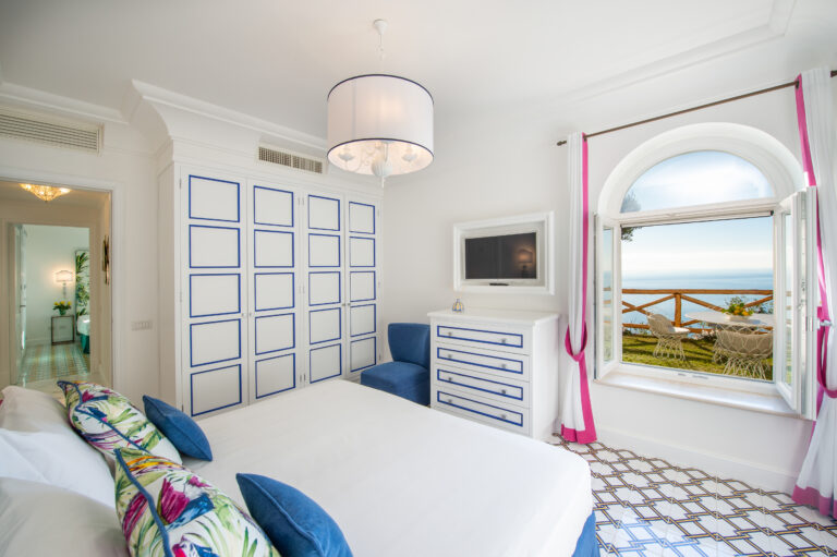 Villa Nuea — White bedroom with garden door and louvred shutters